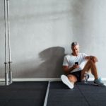 Mature man checking his messages after a health club workout