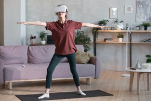 Woman exercising virtually in the room at home