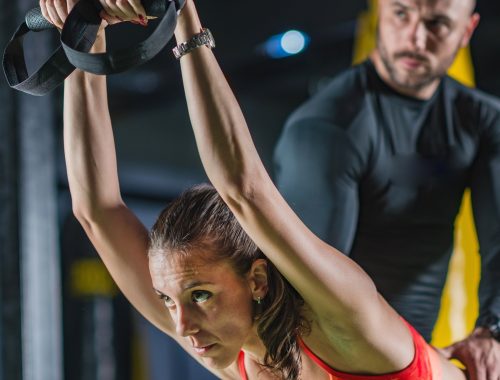 Personal trainer with woman in the gym